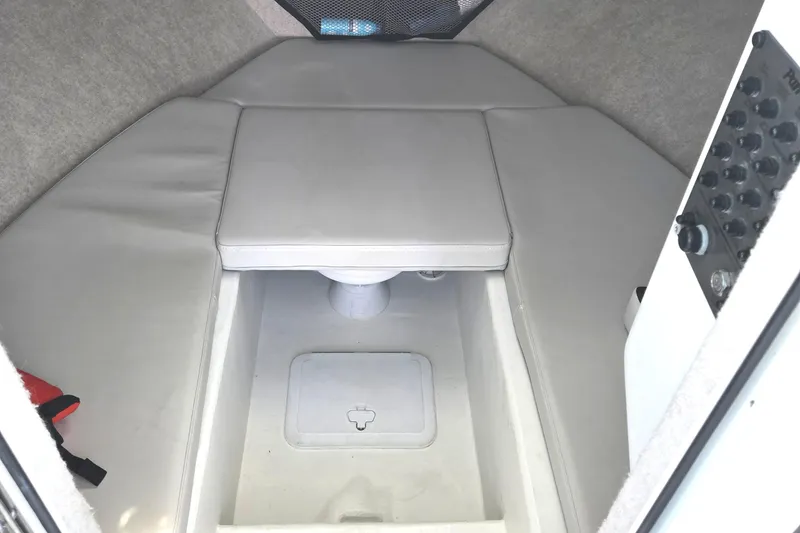 Slide: The Image of 2022 Parker 2520 XLD Sport Cabin interior with cushioned seating and storage compartment. - 13