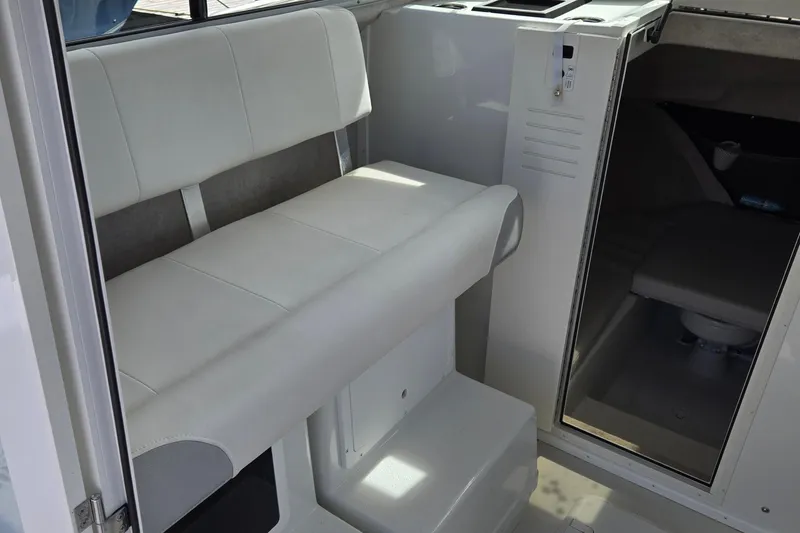 Slide: The Image of 2022 Parker 2520 XLD Sport Cabin interior with white seating and compact cabin space. - 2