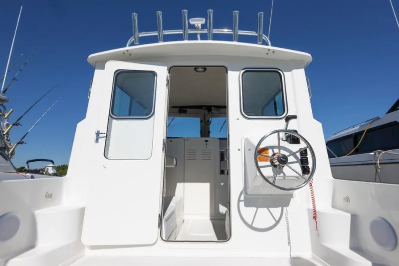 Slide: The Image of Manufacturer Provided Image: 2022 Parker 2520 XLD Sport Cabin boat, rear view of cabin and helm. - 6