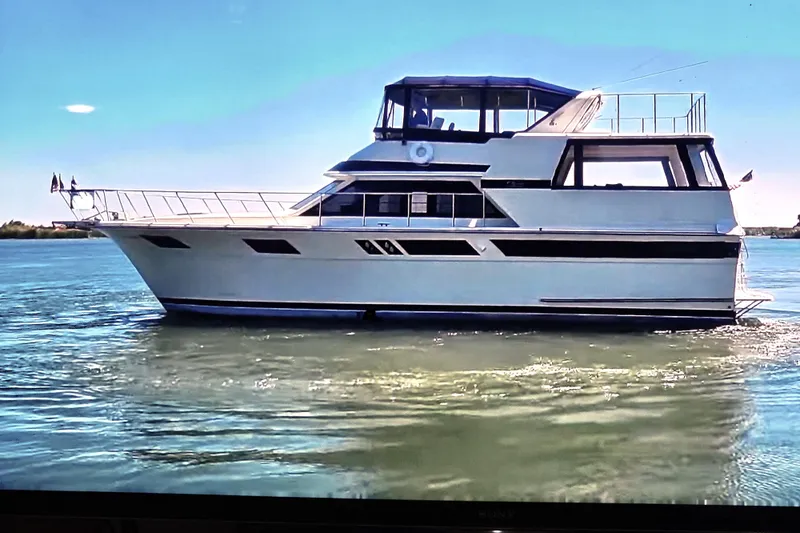 The Image of 1986 Californian 48 Motor Yacht cruising on calm waters under clear skies. - 0