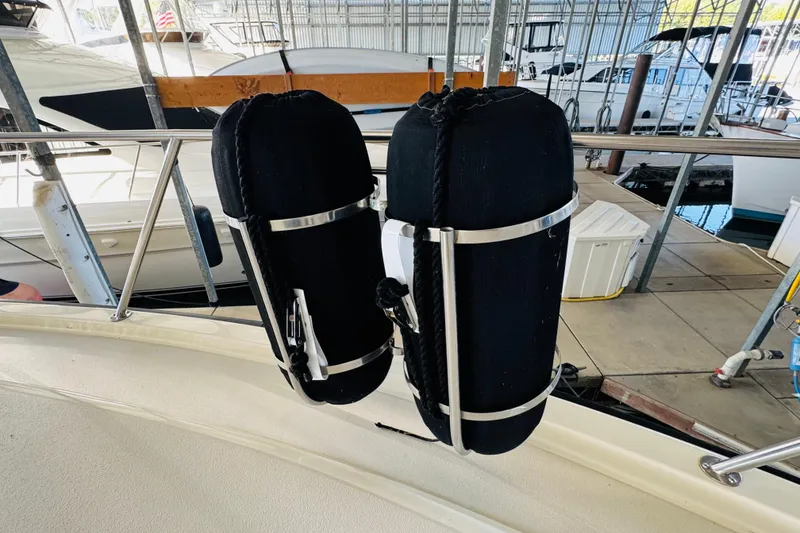 Slide: The Image of Fenders on 1986 Californian 48 Motor Yacht, docked in a marina. - 11