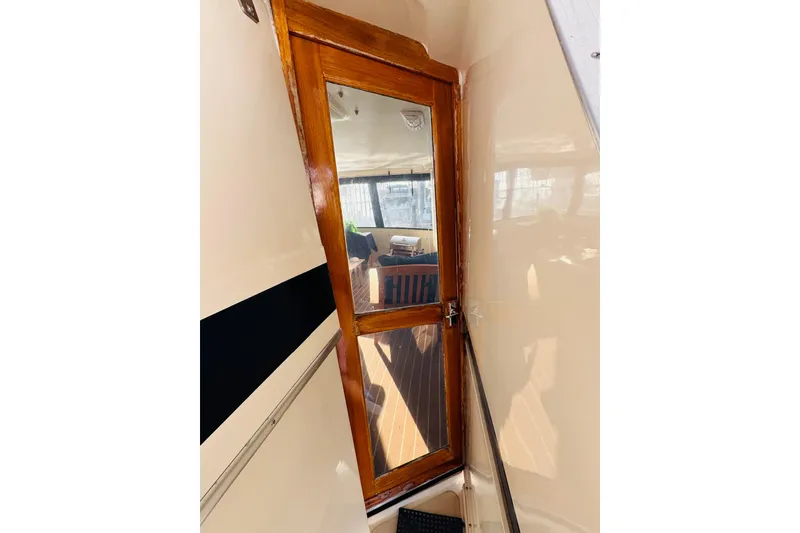 Slide: The Image of Wooden door with glass panel on 1986 Californian 48 Motor Yacht interior. - 13