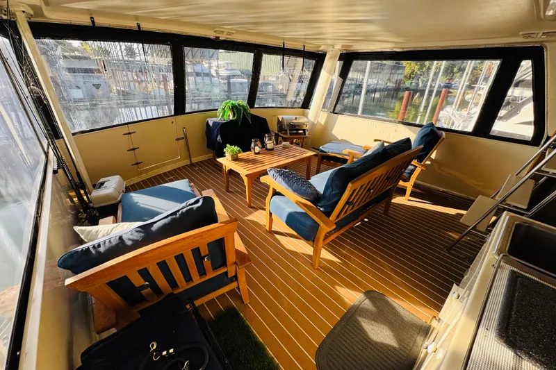 Slide: The Image of 1986 Californian 48 Motor Yacht interior with cozy seating and panoramic windows. - 15
