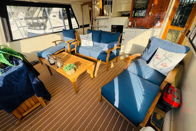 Slide: The Image of Luxurious 1986 Californian 48 Motor Yacht interior with cozy seating and nautical decor. - 16