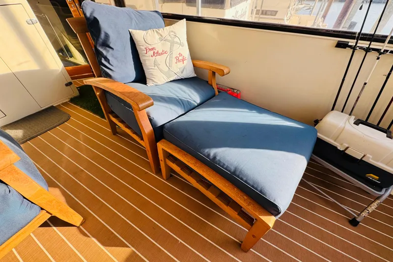 Slide: The Image of Luxurious seating area on 1986 Californian 48 Motor Yacht with blue cushions and nautical decor. - 18