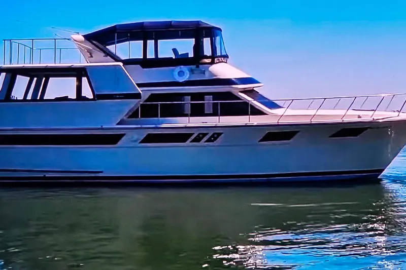 Slide: The Image of 1986 Californian 48 Motor Yacht on calm water under clear blue sky. - 2