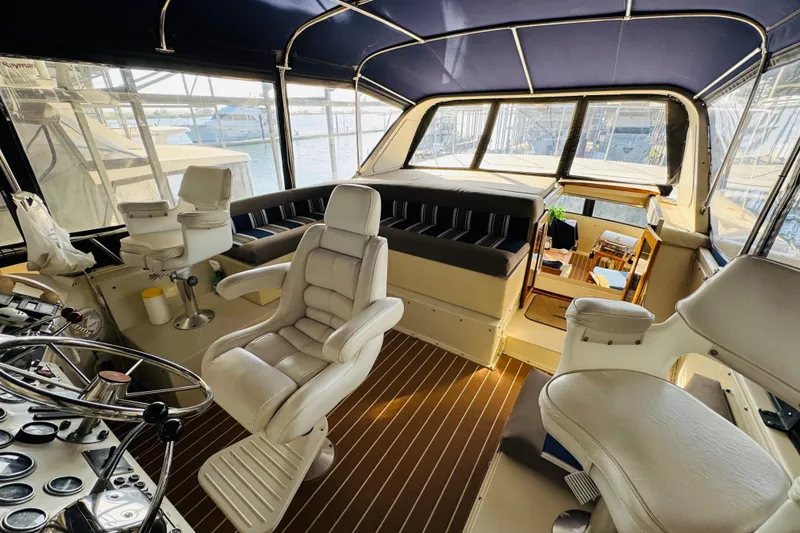 Slide: The Image of 1986 Californian 48 Motor Yacht interior with helm, seating, and panoramic windows. - 26
