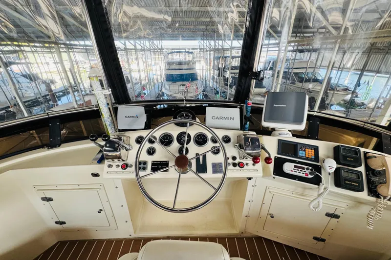 Slide: The Image of Cockpit of 1986 Californian 48 Motor Yacht with navigation equipment and steering wheel. - 28