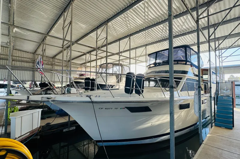 Slide: The Image of 1986 Californian 48 Motor Yacht docked in covered marina. - 3