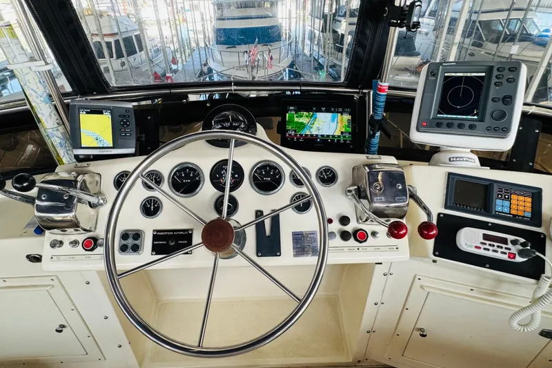 Slide: The Image of Helm of 1986 Californian 48 Motor Yacht with navigation instruments and steering wheel. - 34