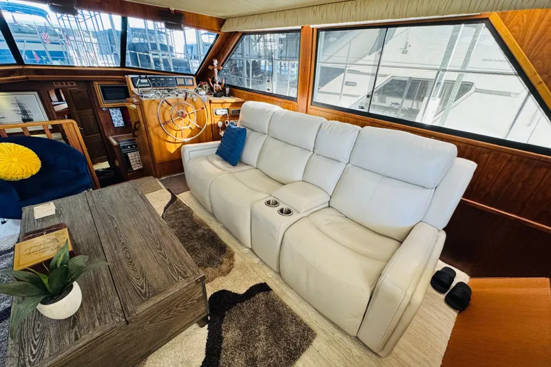 Slide: The Image of Interior of 1986 Californian 48 Motor Yacht with plush seating and wooden accents. - 36