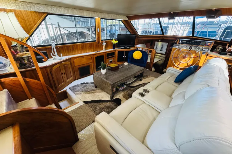 Slide: The Image of Luxurious interior of a 1986 Californian 48 Motor Yacht with plush seating and wooden accents. - 37