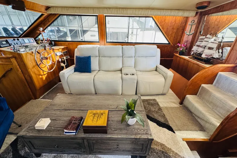 Slide: The Image of Interior of 1986 Californian 48 Motor Yacht with white sofa, wooden accents, and nautical decor. - 39