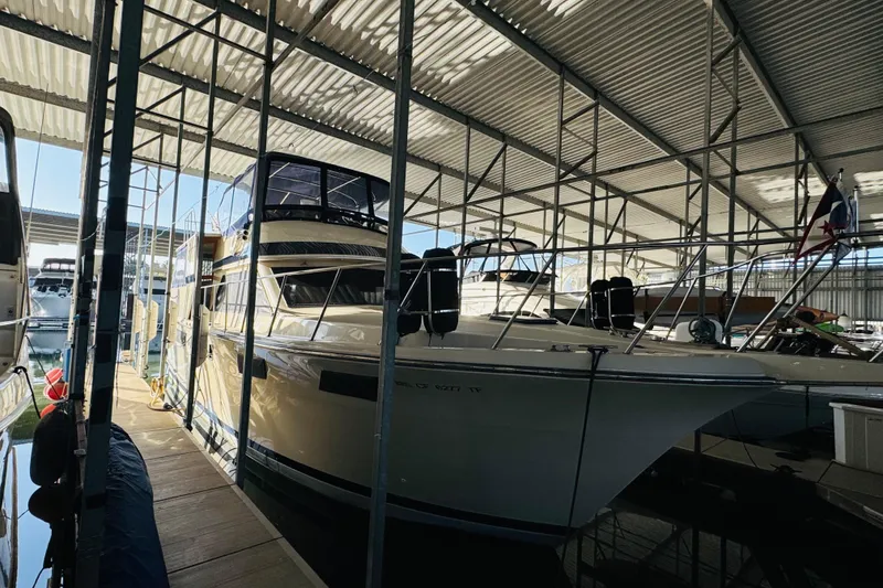 Slide: The Image of 1986 Californian 48 Motor Yacht docked in a covered marina. - 4