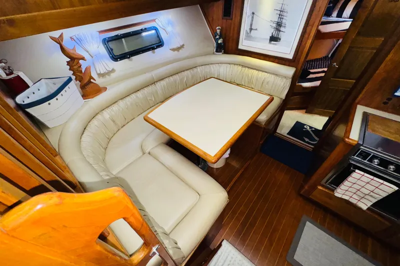 Slide: The Image of Interior of 1986 Californian 48 Motor Yacht with cozy dining area and nautical decor. - 47