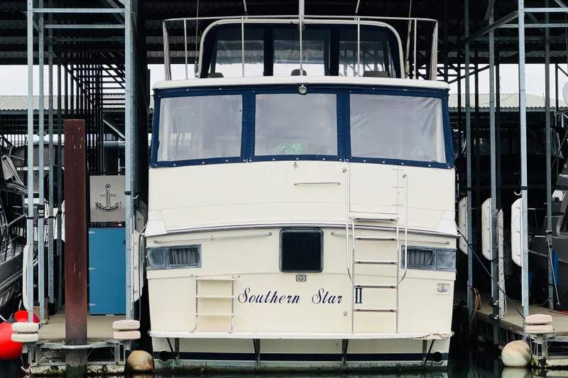 Slide: The Image of 1986 Californian 48 Motor Yacht docked, named "Southern Star," in a covered marina. - 5