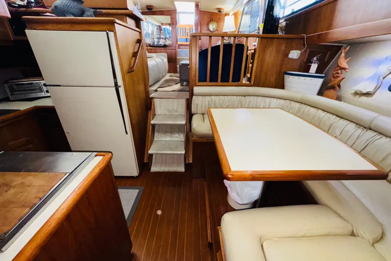 Slide: The Image of Interior of 1986 Californian 48 Motor Yacht with dining area and kitchen. - 50
