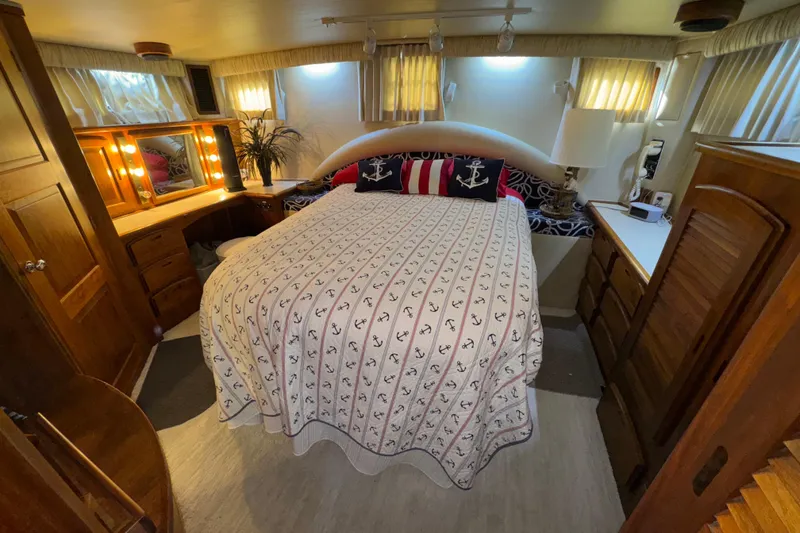 Slide: The Image of Luxurious bedroom interior of 1986 Californian 48 Motor Yacht with nautical-themed decor. - 52