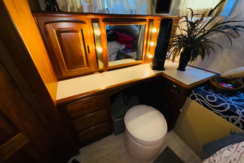 Slide: The Image of Vanity area in 1986 Californian 48 Motor Yacht with mirror, lights, and wooden cabinetry. - 56