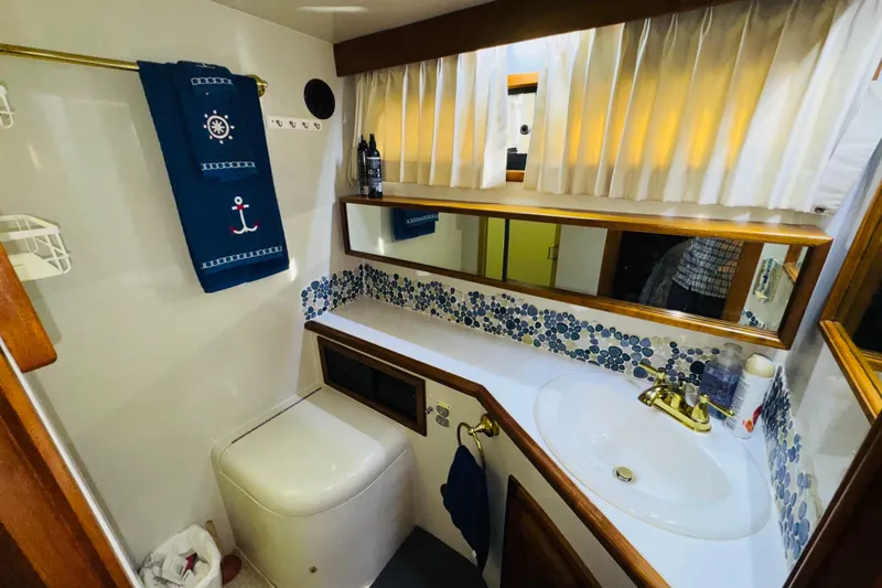 Slide: The Image of Bathroom interior of 1986 Californian 48 Motor Yacht with nautical decor and modern amenities. - 58