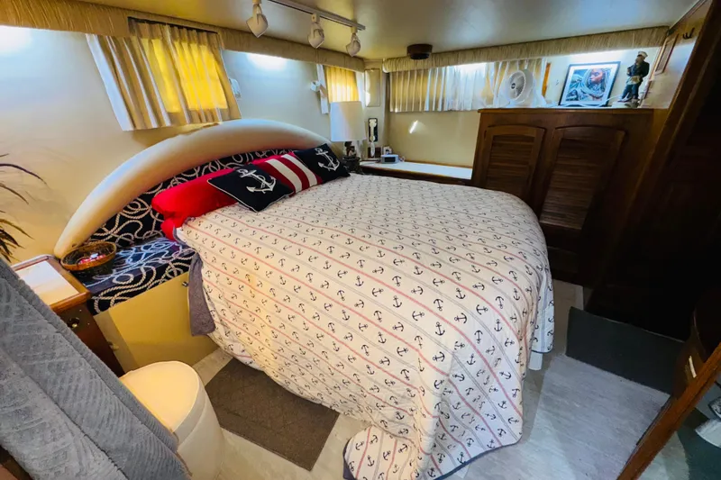 Slide: The Image of Cozy bedroom in 1986 Californian 48 Motor Yacht with nautical-themed bedding and decor. - 60