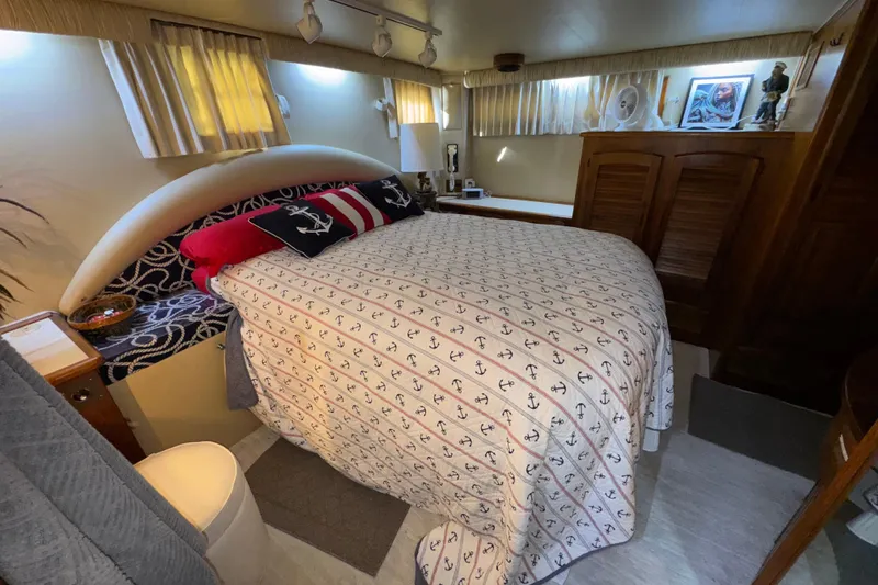 Slide: The Image of Cozy bedroom in 1986 Californian 48 Motor Yacht with nautical-themed decor. - 61