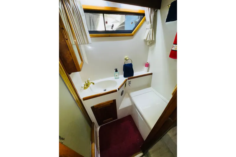 Slide: The Image of Bathroom interior of 1986 Californian 48 Motor Yacht with sink and window. - 63