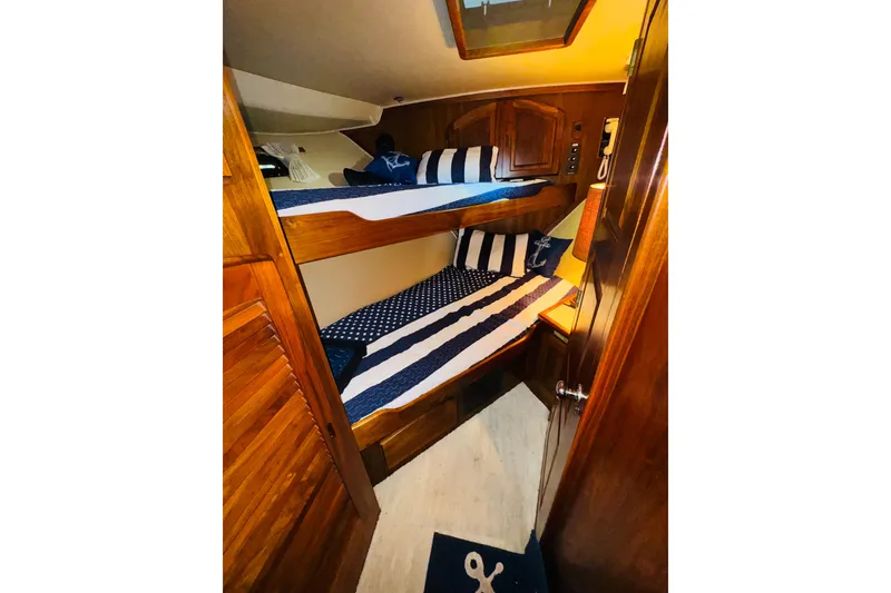 Slide: The Image of 1986 Californian 48 Motor Yacht cabin with wooden bunk beds and nautical decor. - 64