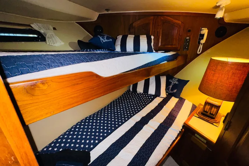 Slide: The Image of Cozy cabin with bunk beds in 1986 Californian 48 Motor Yacht, featuring nautical-themed decor. - 65