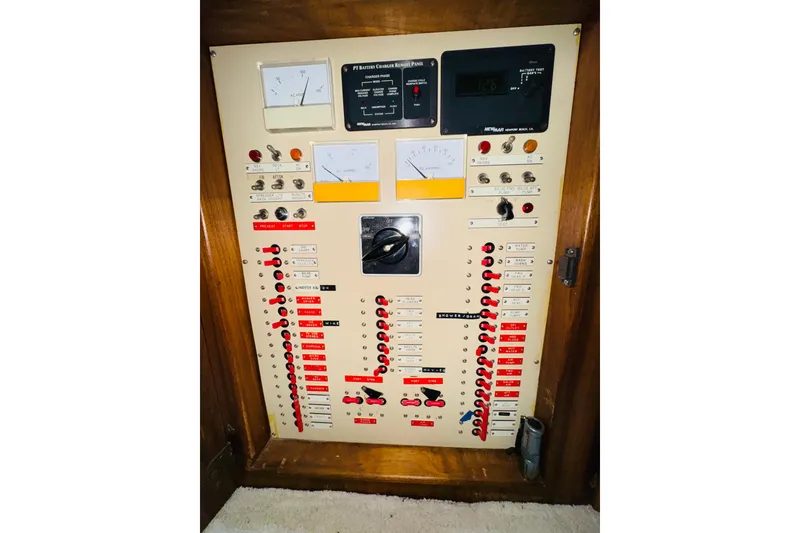 Slide: The Image of Electrical control panel on a 1986 Californian 48 Motor Yacht, featuring gauges and switches. - 67