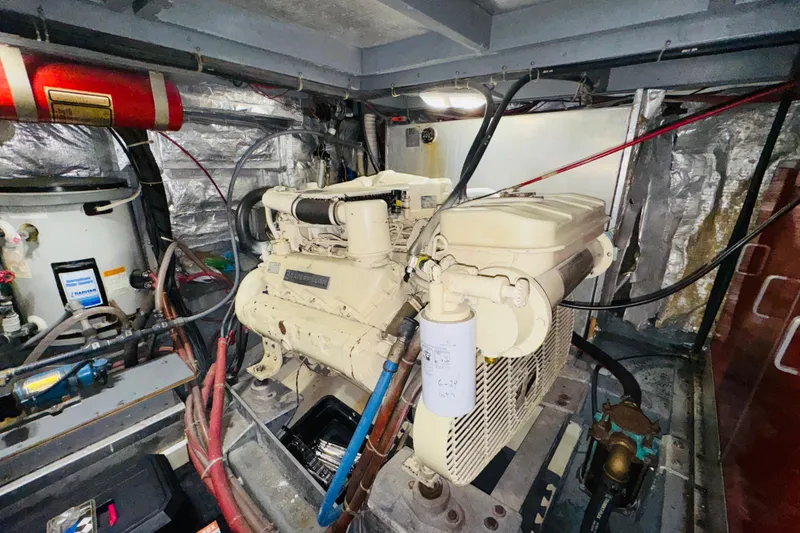 Slide: The Image of Engine room of a 1986 Californian 48 Motor Yacht, featuring a diesel engine. - 70