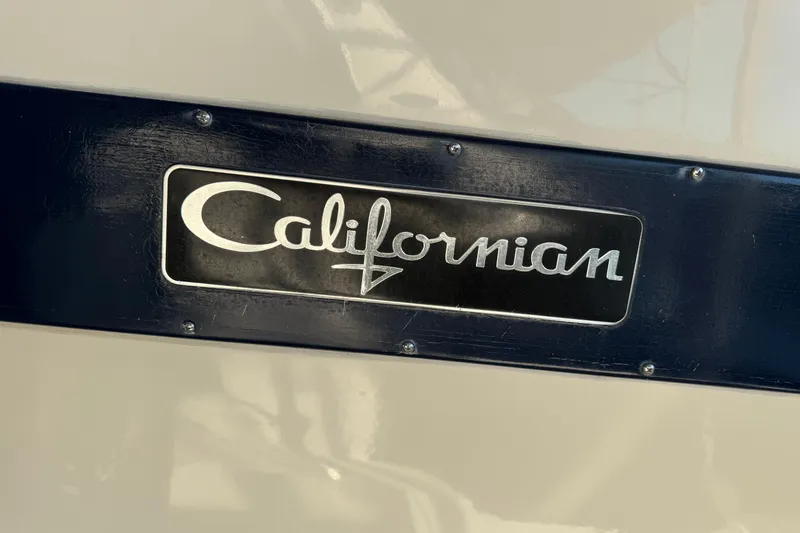 Slide: The Image of 1986 Californian 48 Motor Yacht nameplate on a dark background. - 77