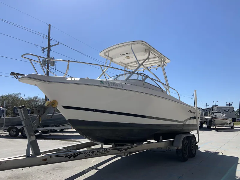 Slide: The Image of 2007 Pro-Line 21 Walk boat on trailer under clear blue sky. - 12