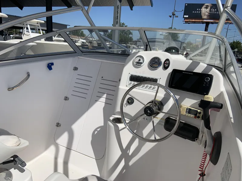 Slide: The Image of 2007 Pro-Line 21 Walk boat cockpit with steering wheel and navigation instruments. - 15