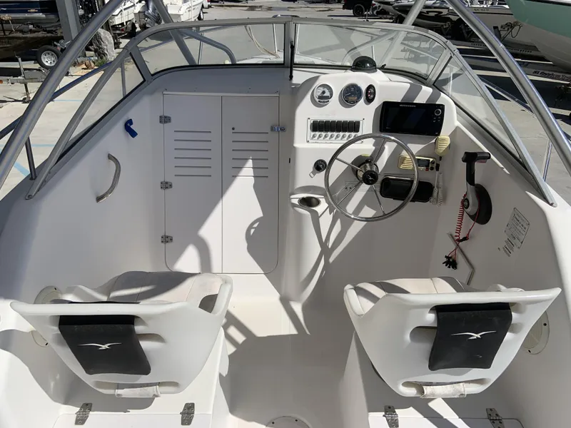 Slide: The Image of 2007 Pro-Line 21 Walk boat cockpit with steering wheel and control panel. - 16