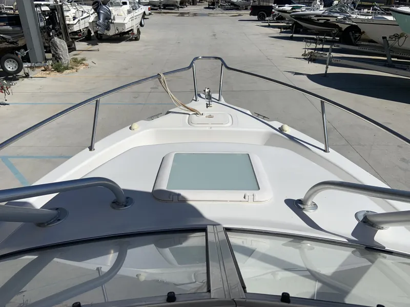 Slide: The Image of 2007 Pro-Line 21 Walk boat deck view in a marina with other boats. - 17