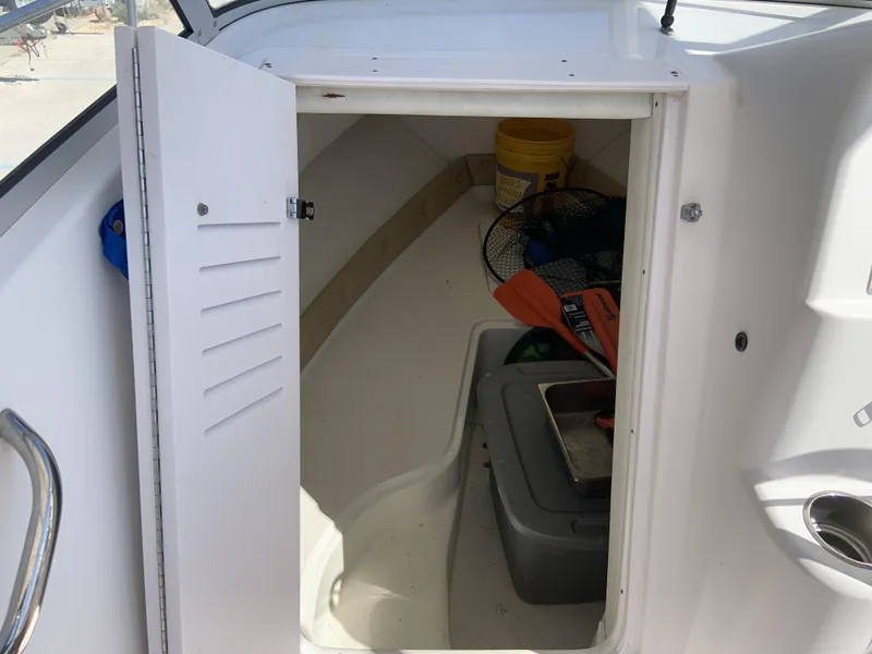 Slide: The Image of 2007 Pro-Line 21 Walk boat storage compartment with fishing gear and supplies. - 18