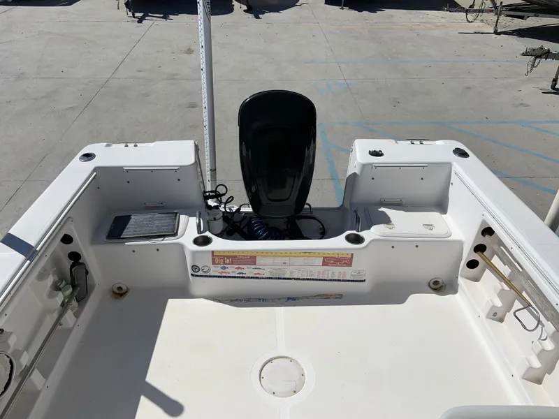 Slide: The Image of 2007 Pro-Line 21 Walk boat interior with motor, spacious deck, and storage compartments. - 19