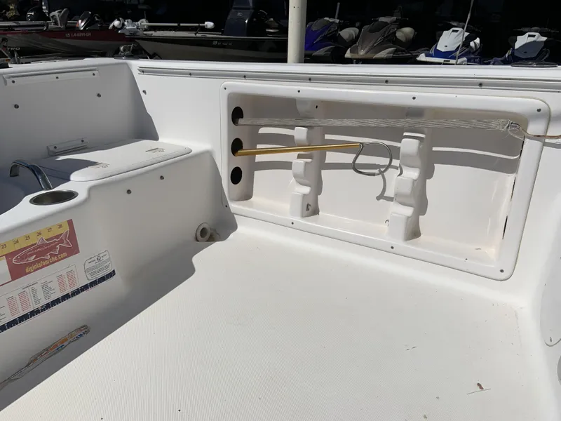 Slide: The Image of 2007 Pro-Line 21 Walk boat interior with fishing rod holder and storage compartment. - 22