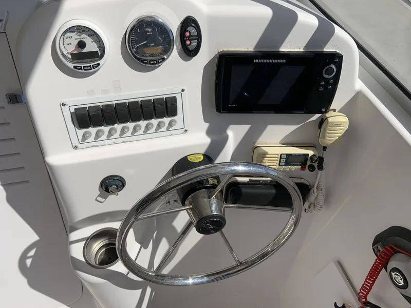 Slide: The Image of 2007 Pro-Line 21 Walk boat dashboard with steering wheel, gauges, and navigation equipment. - 6