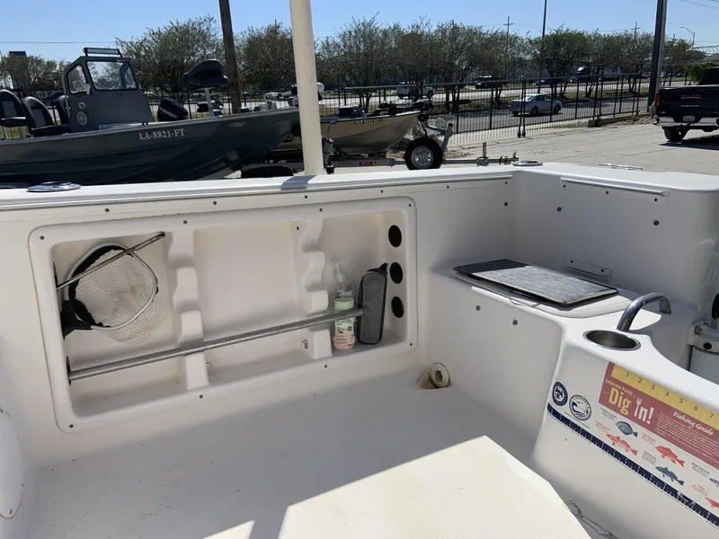 Slide: The Image of 2007 Pro-Line 21 Walk boat interior with storage compartments and fishing gear. - 8