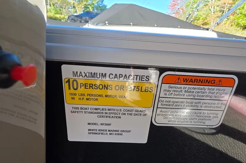 Slide: The Image of 2023 Ranger Reata 200F capacity label: 10 persons or 1375 lbs, safety warnings included. - 10