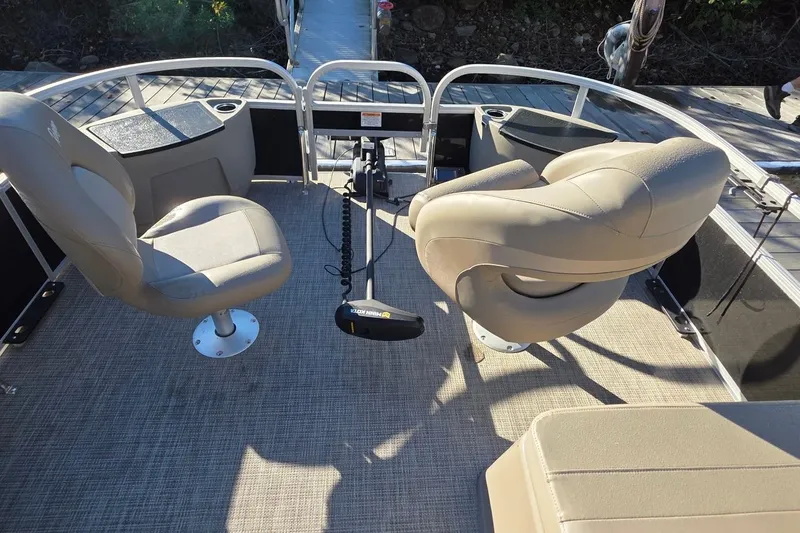 Slide: The Image of 2023 Ranger Reata 200F boat interior with beige seats and fishing equipment. - 12