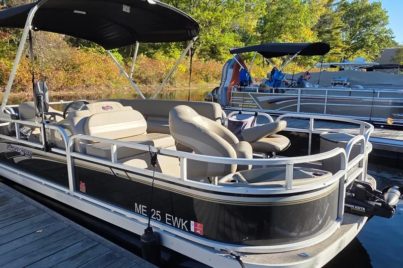 Slide: The Image of 2023 Ranger Reata 200F pontoon boat docked, featuring comfortable seating and canopy. - 4