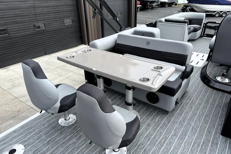Slide: The Image of Premier 230 Solaris RS 2026 boat interior with seating and table, featuring modern design and cup holders. - 13