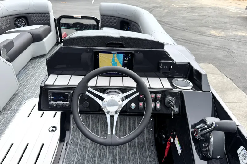 Slide: The Image of 2026 Premier 230 Solaris RS boat dashboard with steering wheel, navigation screen, and controls. - 20
