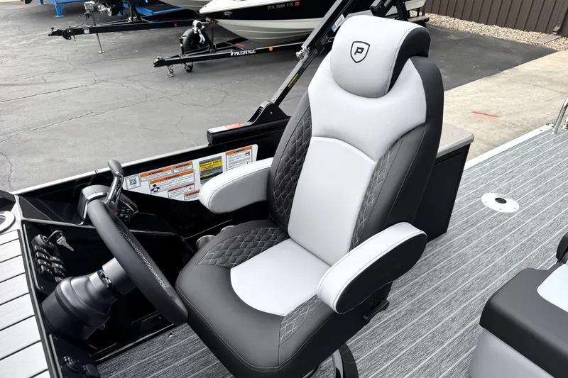 Slide: The Image of Captain's chair in 2026 Premier 230 Solaris RS boat, featuring sleek design and modern controls. - 21
