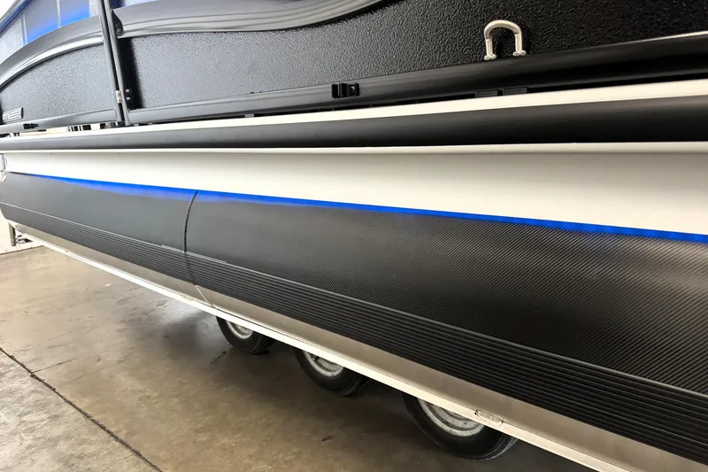 Slide: The Image of 2026 Premier 230 Solaris RS pontoon boat with sleek black and blue detailing. - 34