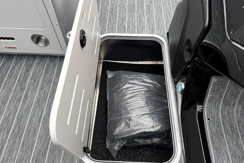 Slide: The Image of Open storage compartment in 2026 Premier 230 Solaris RS boat with bag inside. - 43
