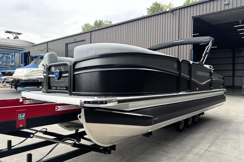 Slide: The Image of 2026 Premier 230 SOLARIS RS pontoon boat in a storage facility. - 5